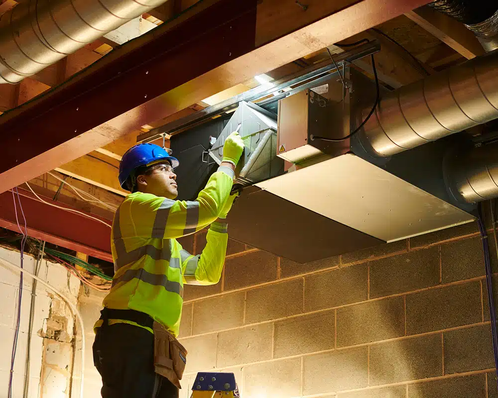 Technician cleaning HVAC ducts