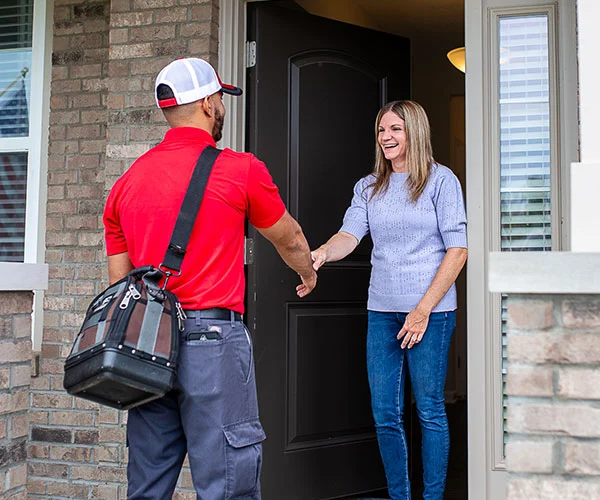 Technician greeting a customer at the door
